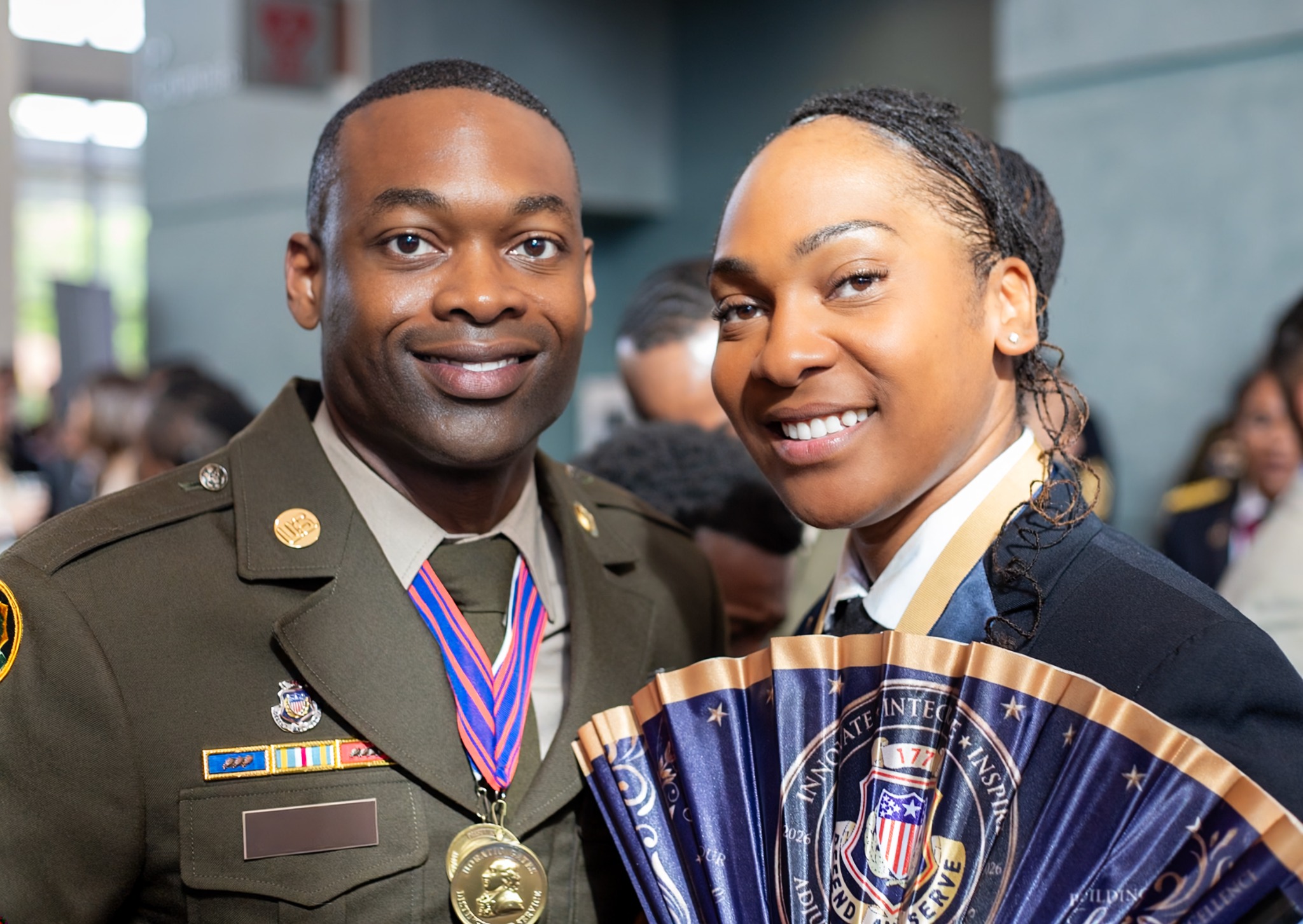 Two service members smiling at a military ceremony